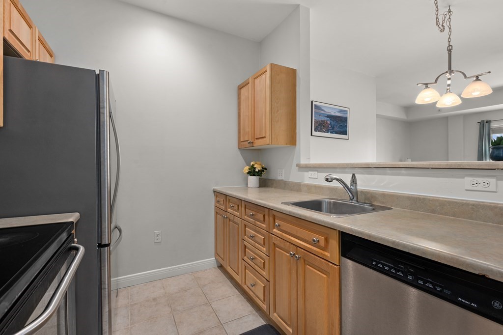 8 Walnut Street, Unit 406 Peabody, MA 01960 - Photo 11 of 31 a kitchen with a sink and a refrigerator