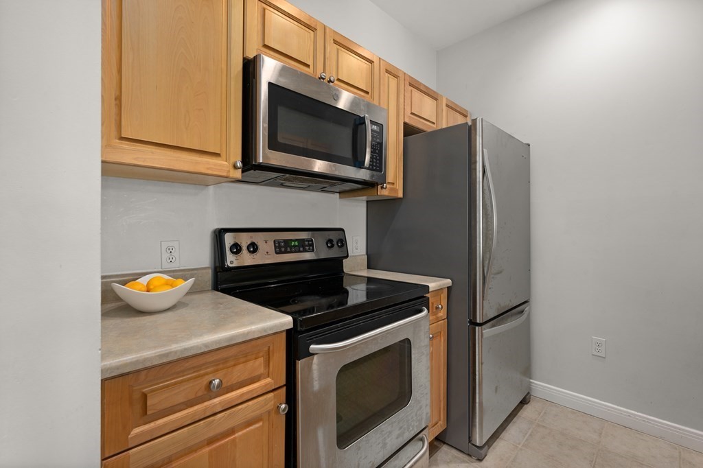 8 Walnut Street, Unit 406 Peabody, MA 01960 - Photo 12 of 31 a kitchen with a stove and a microwave