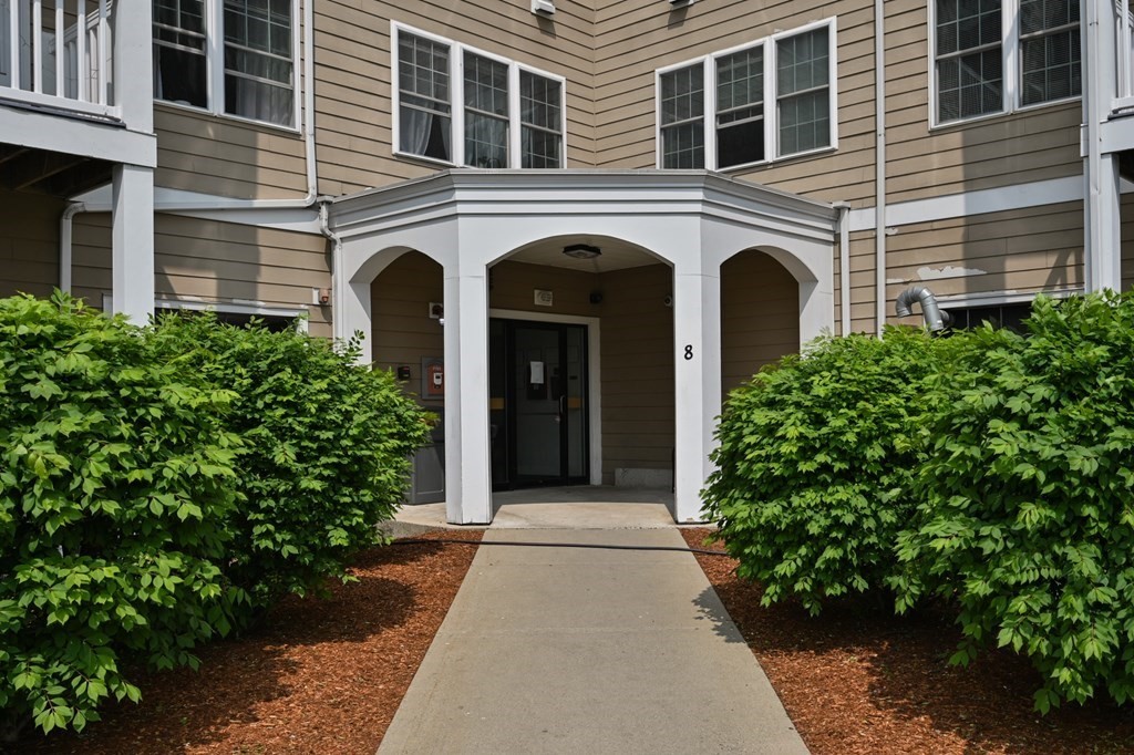 8 Walnut Street, Unit 406 Peabody, MA 01960 - Photo 2 of 31 a front view of a house with garden