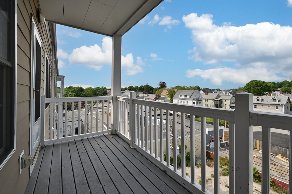 8 Walnut Street, Unit 406 Peabody, MA 01960 - Photo 30 of 31 a view of a balcony with wooden floor & fence