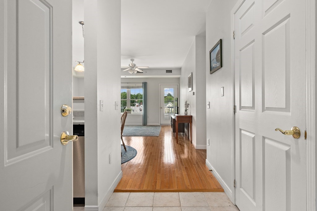 8 Walnut Street, Unit 406 Peabody, MA 01960 - Photo 3 of 31 a hallway with wooden floor fireplace and living room
