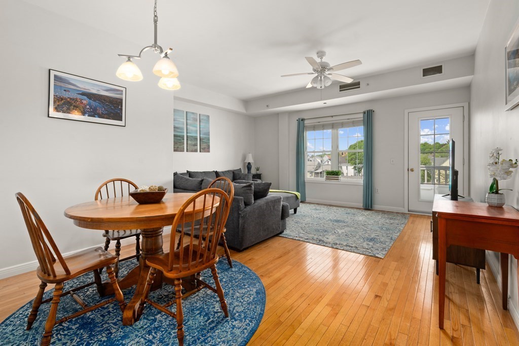 8 Walnut Street, Unit 406 Peabody, MA 01960 - Photo 5 of 31 a living room with furniture a chandelier and a dining table