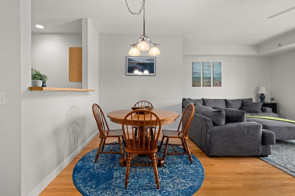 8 Walnut Street, Unit 406 Peabody, MA 01960 - Photo 6 of 31 a living room with furniture a window and a chandelier