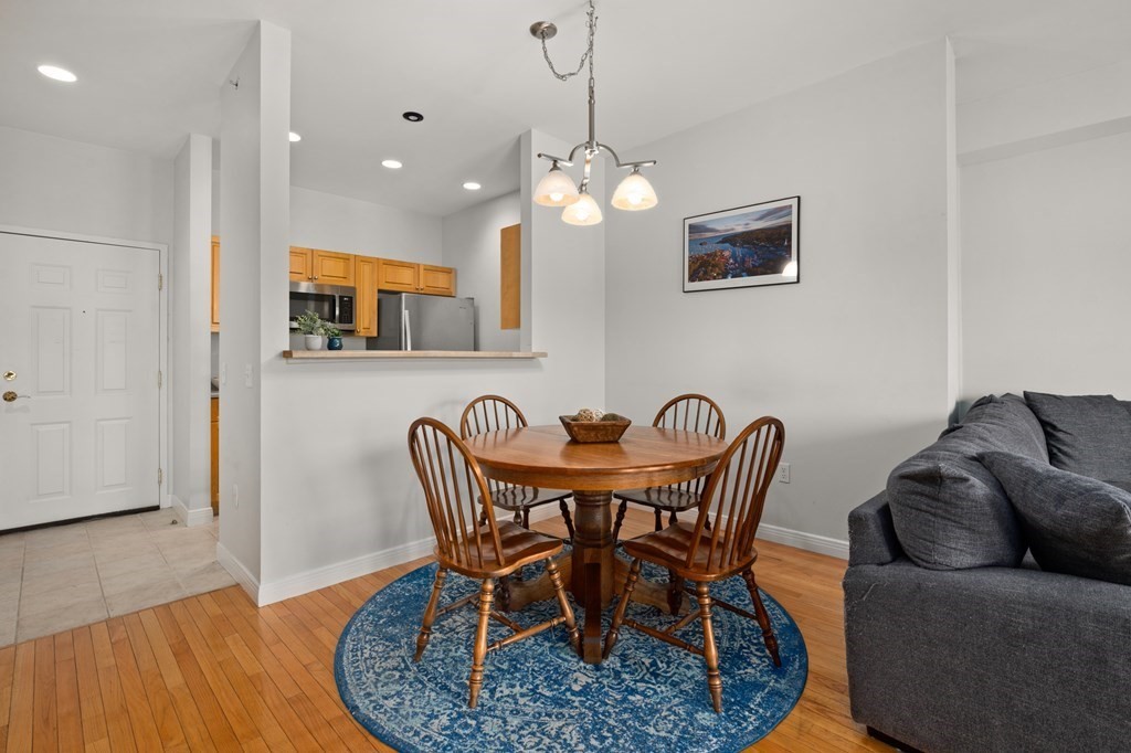 8 Walnut Street, Unit 406 Peabody, MA 01960 - Photo 7 of 31 a view of a dining room with furniture and wooden floor