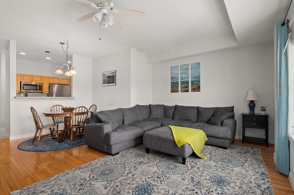8 Walnut Street, Unit 406 Peabody, MA 01960 - Photo 8 of 31 a living room with furniture and a rug