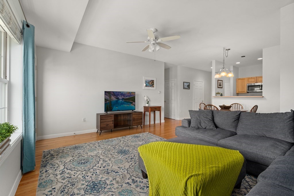 8 Walnut Street, Unit 406 Peabody, MA 01960 - Photo 9 of 31 a living room with furniture and a flat screen tv