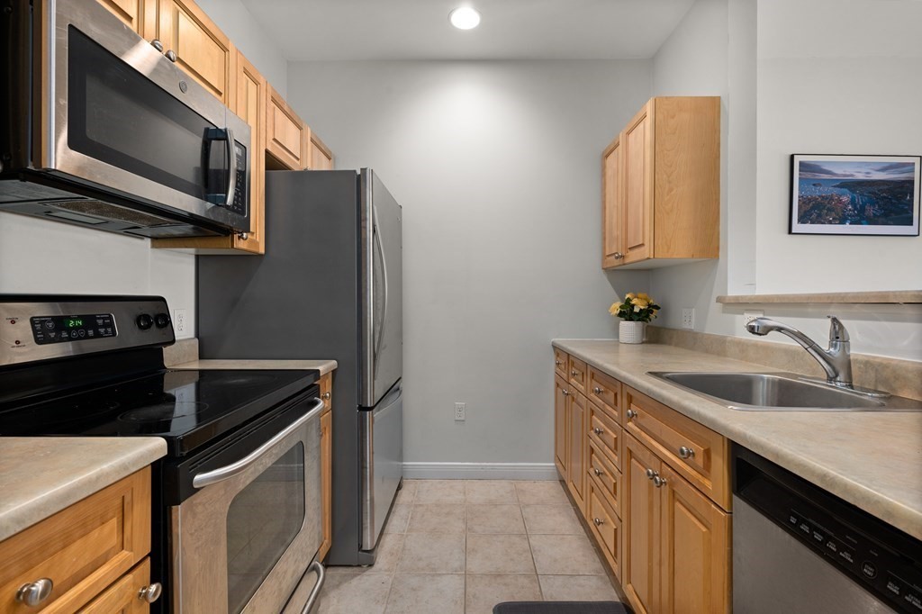 8 Walnut Street, Unit 406 Peabody, MA 01960 - Photo 10 of 31 a kitchen that has a sink and a stove in it