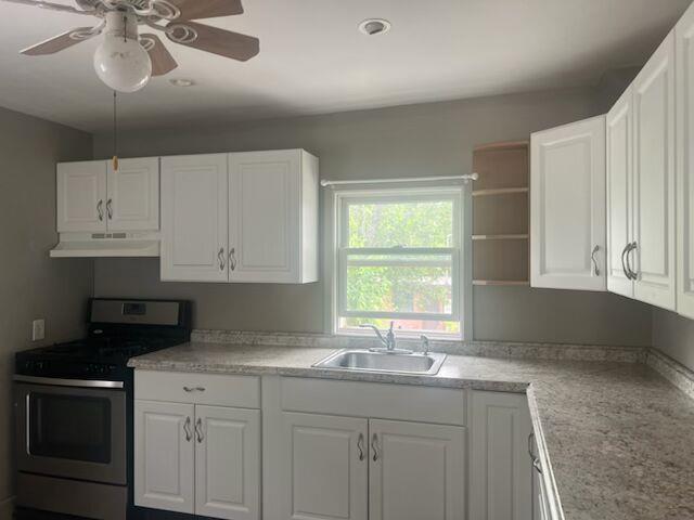 25 Ridge Street Middletown, NY 10940 - Photo 2 of 10 Kitchen with stainless steel gas range oven, white cabinetry, and light countertops