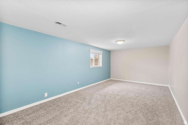 415 East 1150th Street North Logan, UT 84341 - Photo 19 of 38 Spacious room featuring light gray carpeting and a combination of light blue and off-white painted walls