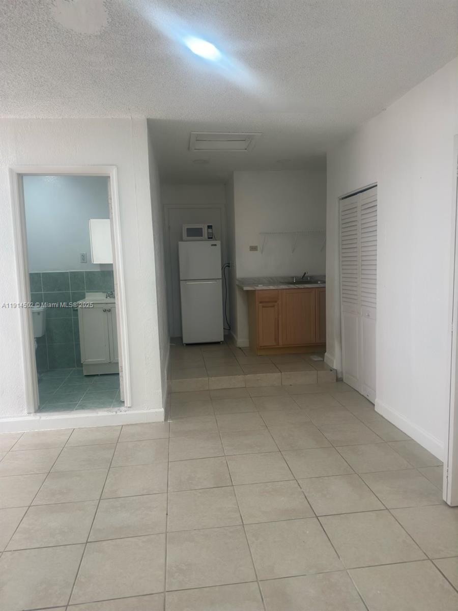 12539 Southwest 259th Street, Unit B Homestead, FL 33032 - Photo 2 of 11 a view of room and window