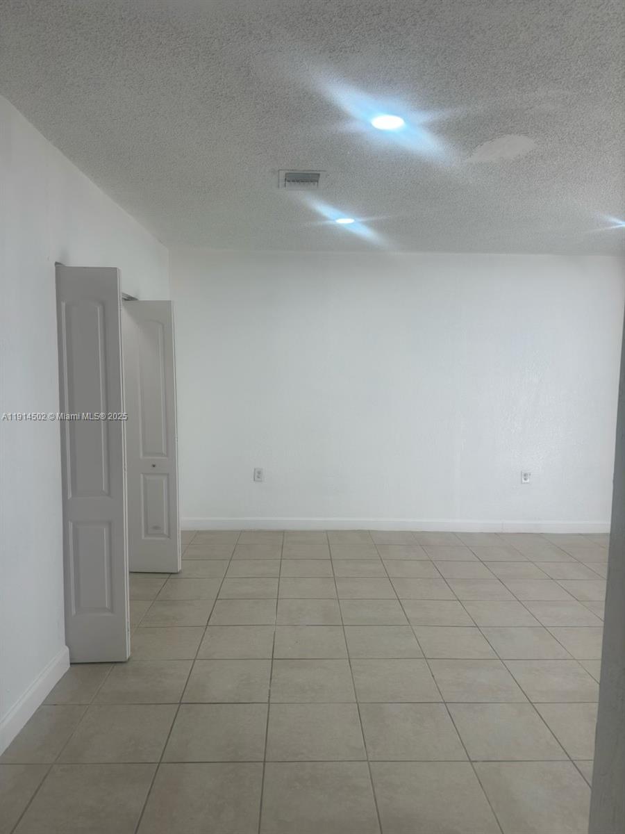 12539 Southwest 259th Street, Unit B Homestead, FL 33032 - Photo 4 of 11 a view of an empty room