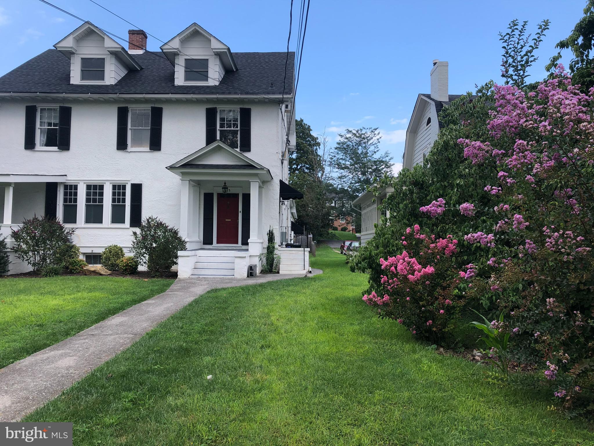 a front view of a house with a garden
