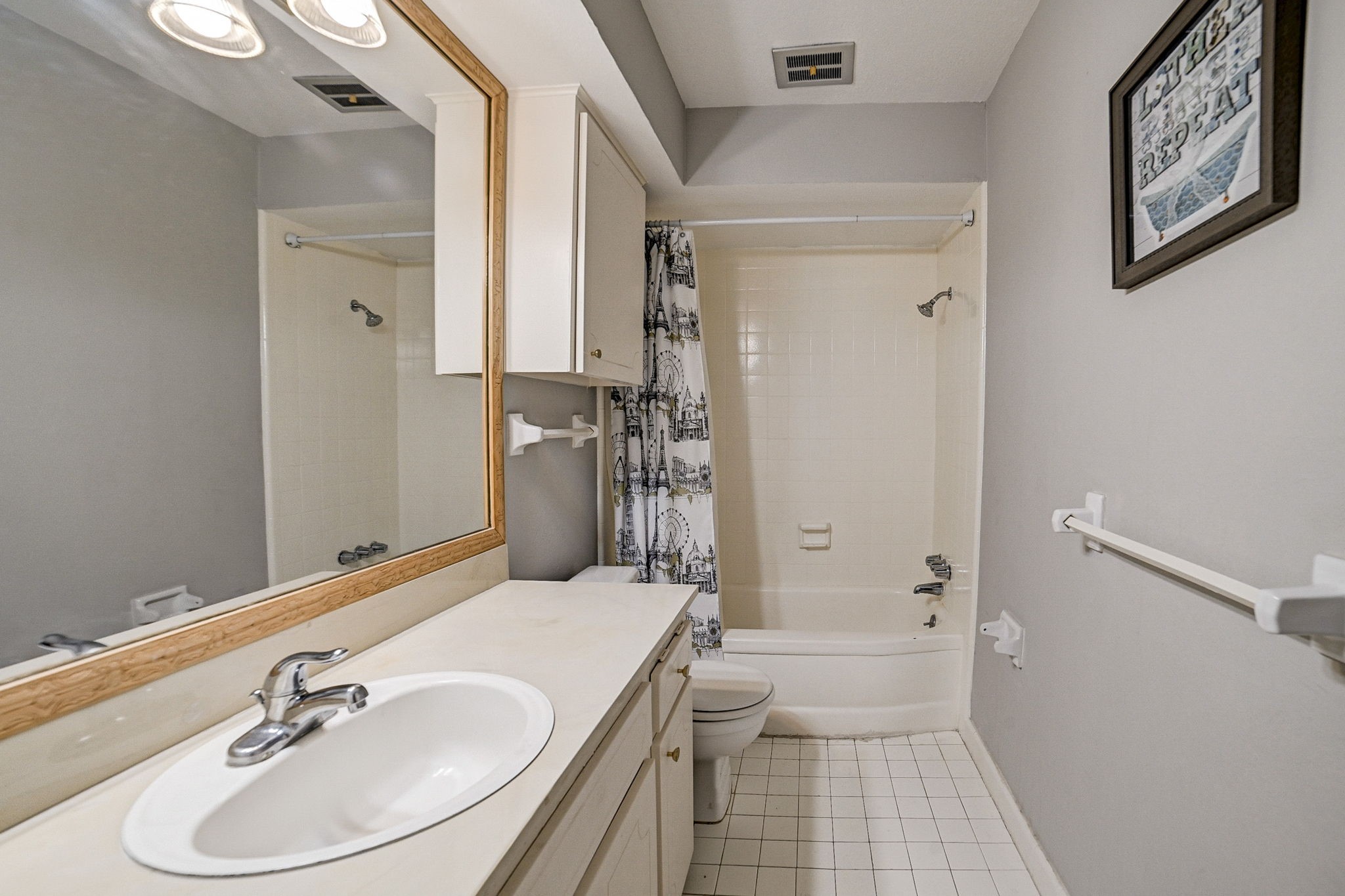 7900 Westheimer Road, Unit 202 Houston, TX 77063 - Photo 16 of 27 a bathroom with a sink a toilet a tub and a mirror