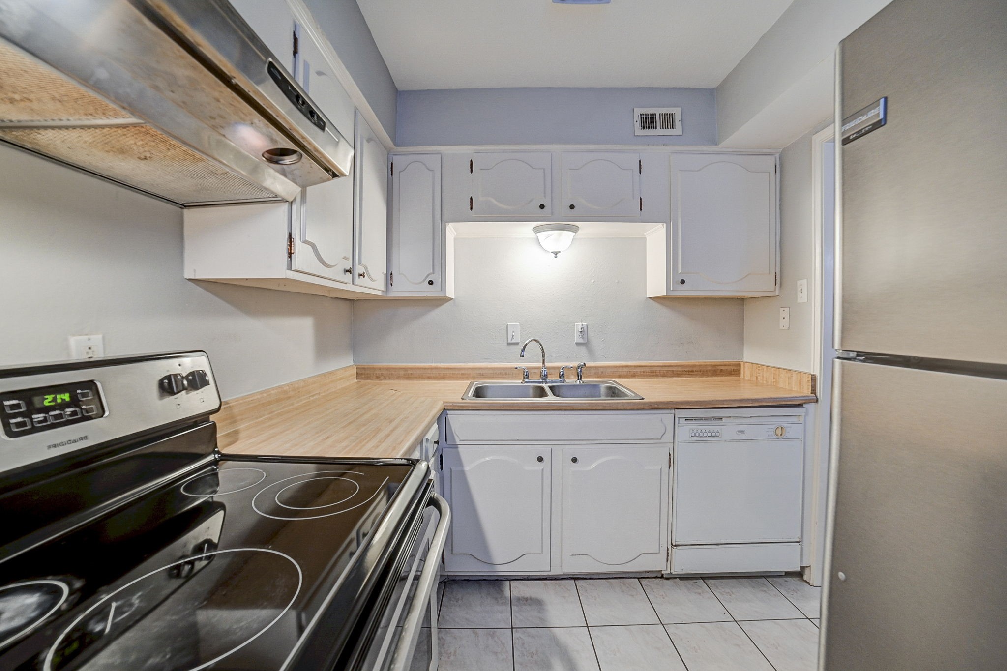 7900 Westheimer Road, Unit 202 Houston, TX 77063 - Photo 18 of 27 a kitchen with a sink appliances and cabinets