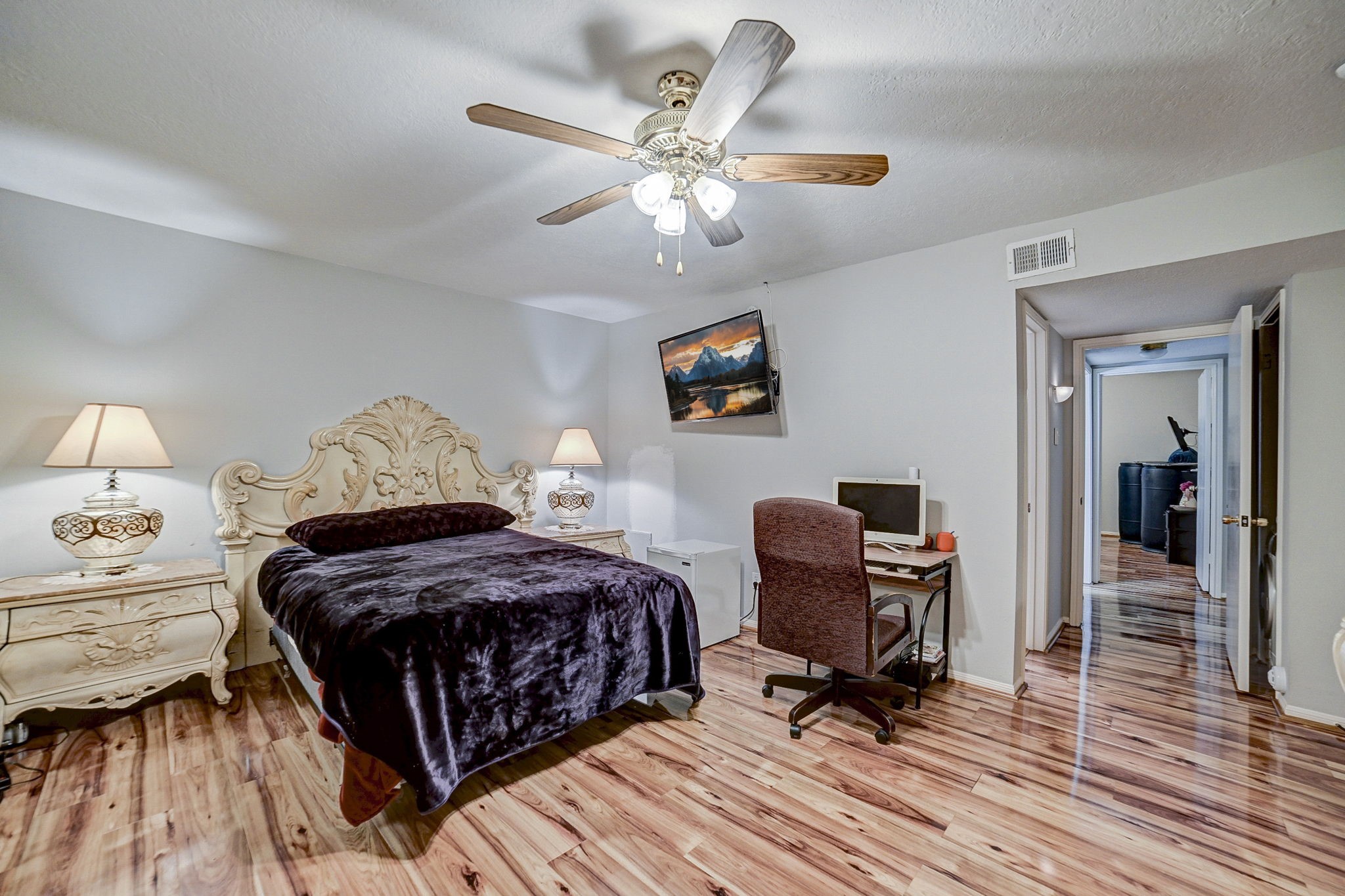 7900 Westheimer Road, Unit 202 Houston, TX 77063 - Photo 19 of 27 a bedroom with a bed and wooden floor