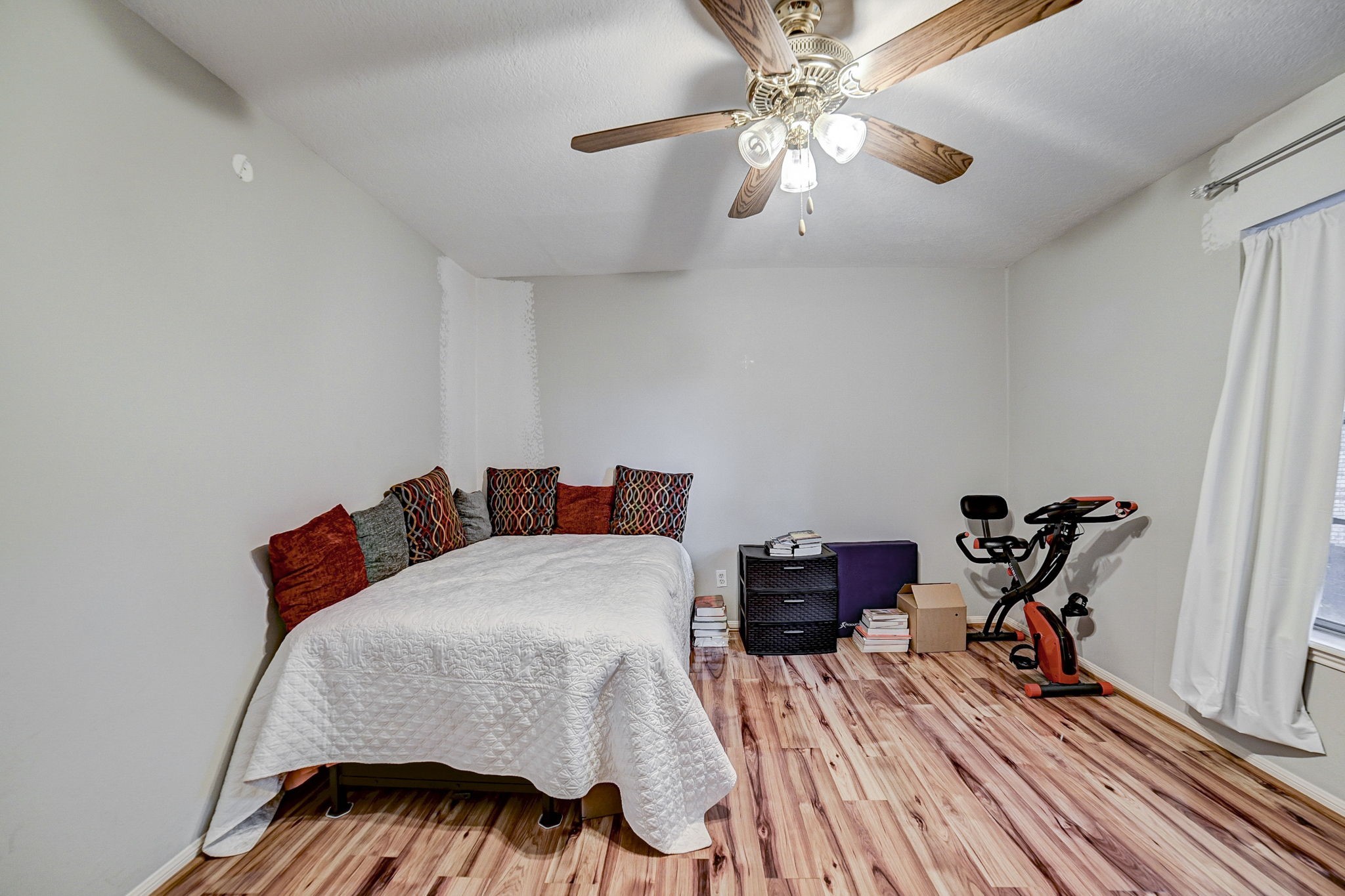 7900 Westheimer Road, Unit 202 Houston, TX 77063 - Photo 22 of 27 a bedroom with bed and wooden floor