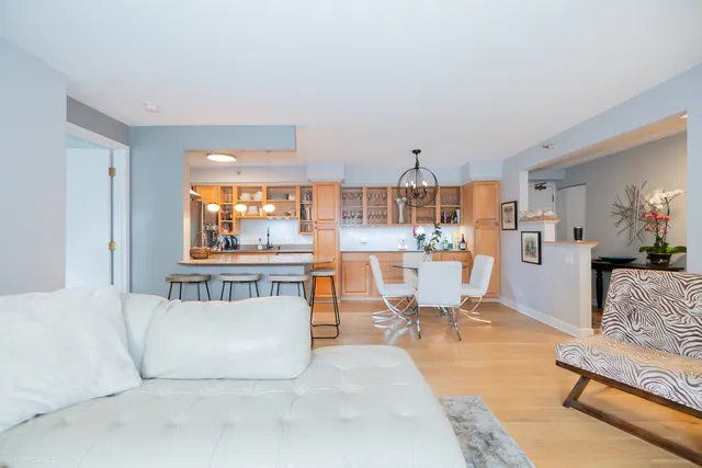a living room with furniture and a kitchen