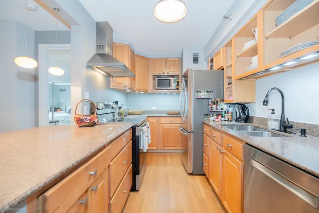 a kitchen with white cabinets and sink