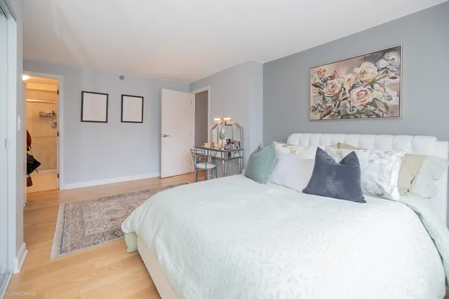 a bedroom with bed and cupboard