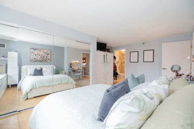 a bedroom with a bed and a couch