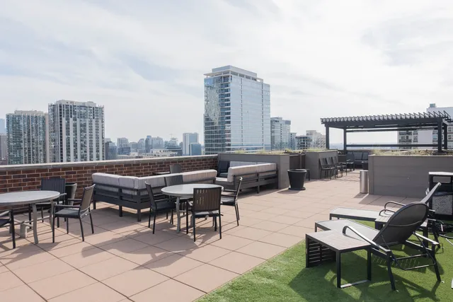a roof deck with table and chairs