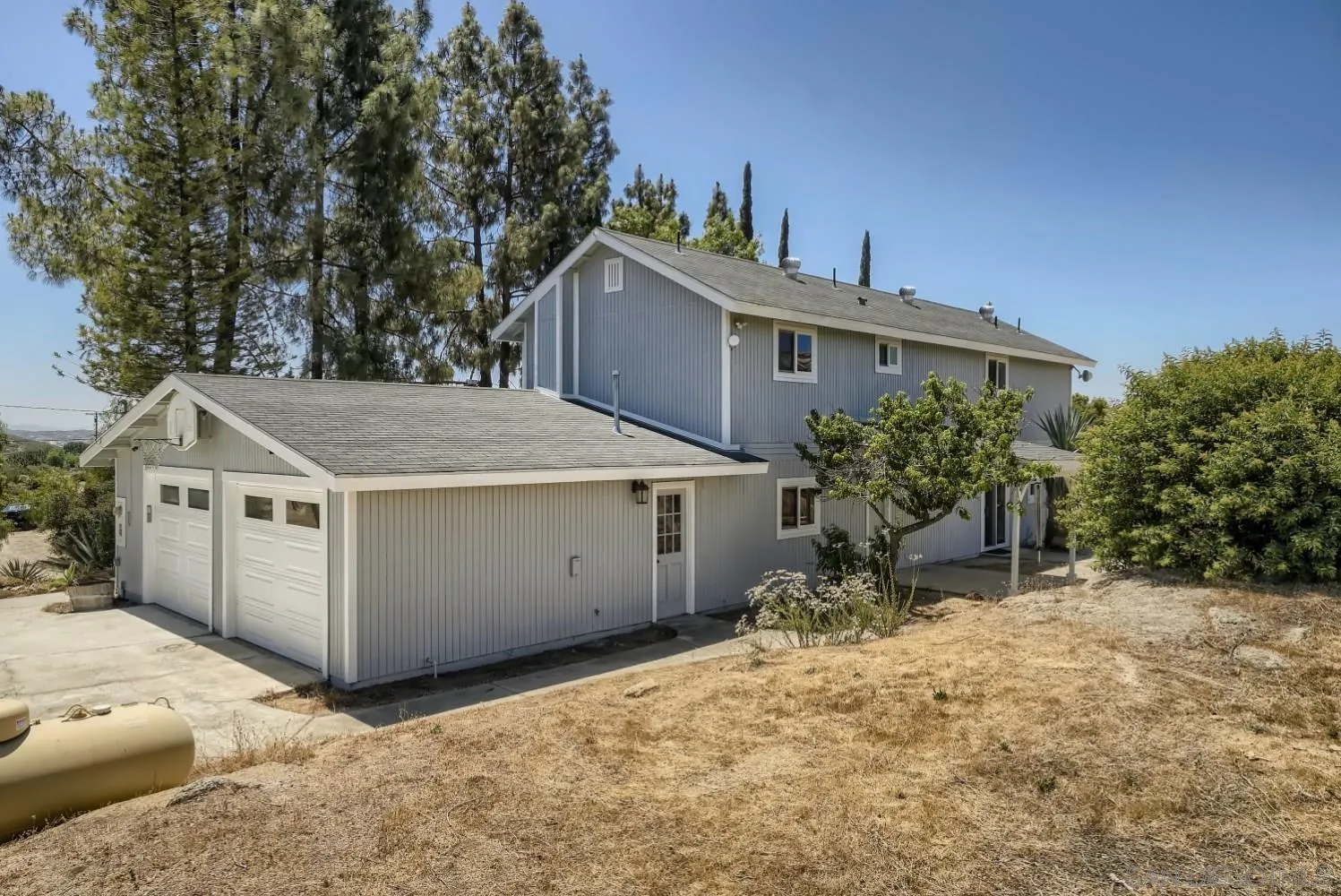 20555 Bee Valley Road Jamul, CA 91935 - Photo 3 of 33 a view of a house with a yard and potted plants