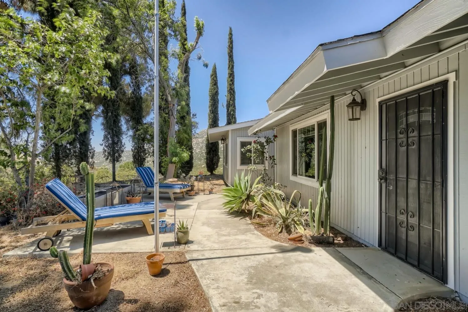 20555 Bee Valley Road Jamul, CA 91935 - Photo 4 of 33 a view of a patio with table and chairs and potted plants