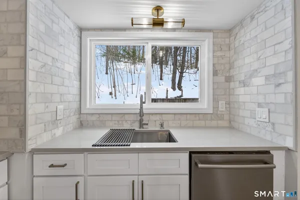 a kitchen with a sink cabinets and window