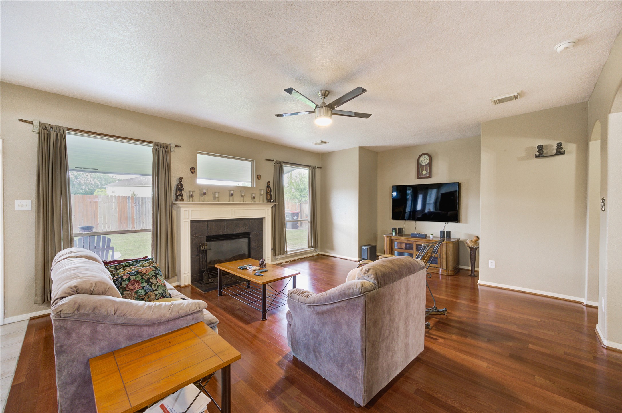 16730 Spring Barker Drive Cypress, TX 77429 - Photo 13 of 50 a living room with furniture a fireplace and a flat screen tv