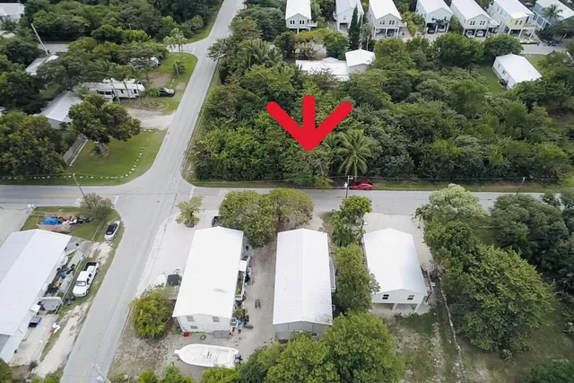 a living room with furniture a table and kitchen view