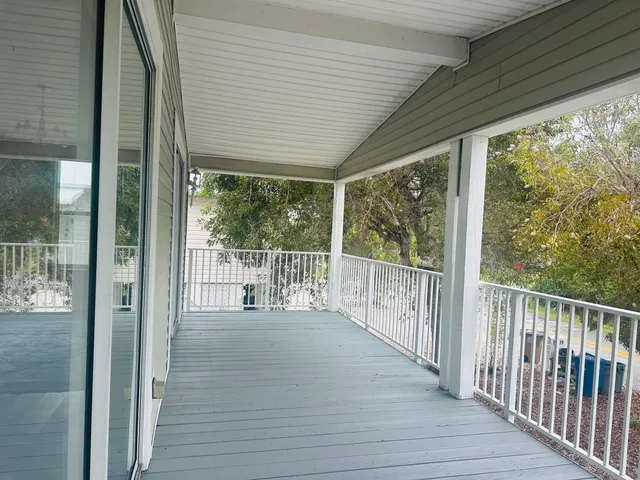 a large kitchen with kitchen island a stove a sink dishwasher and a refrigerator with wooden floor