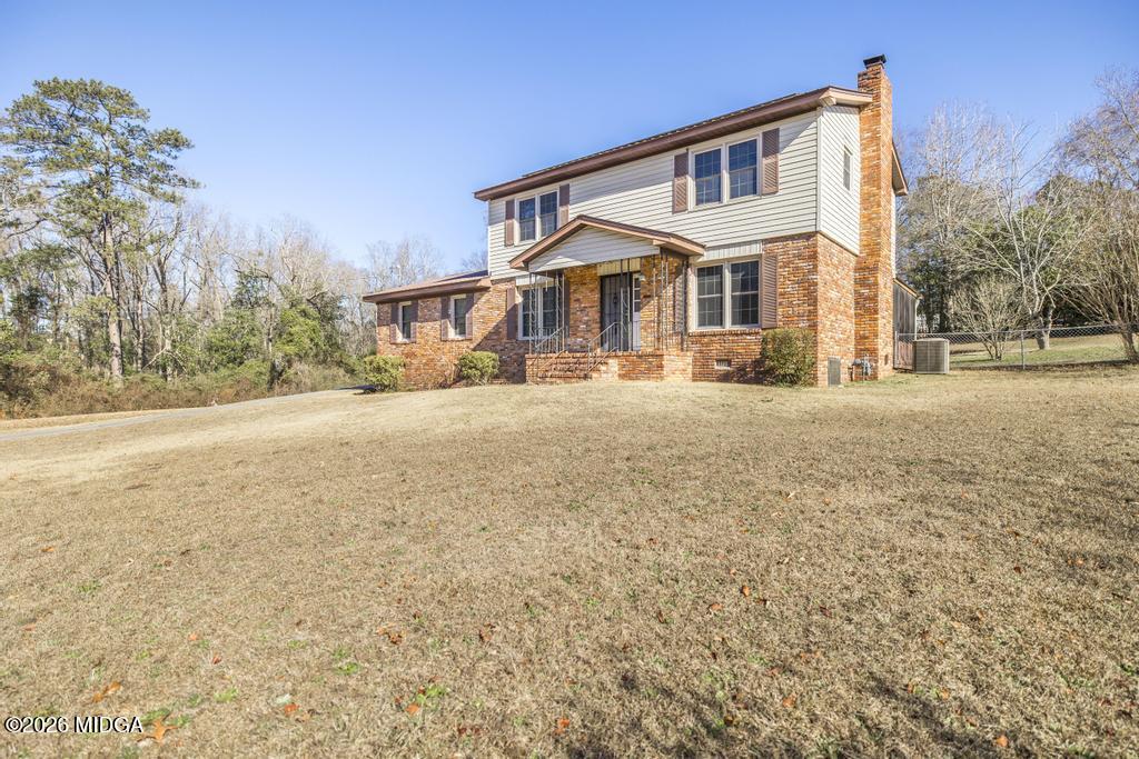 5624 Rogers Road Lizella, GA 31052 - Photo 2 of 39 a front view of a house with a yard and garage