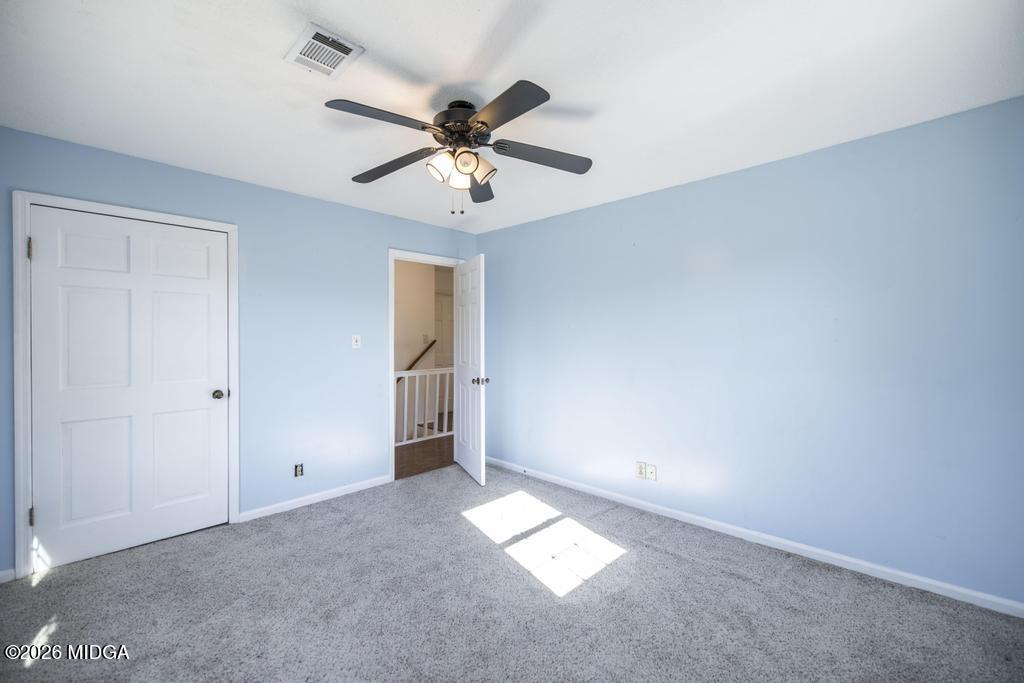 5624 Rogers Road Lizella, GA 31052 - Photo 21 of 39 an empty room with closet and a chandelier fan