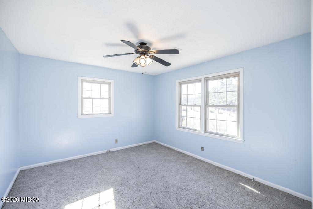 5624 Rogers Road Lizella, GA 31052 - Photo 22 of 39 an empty room with windows and ceiling fan