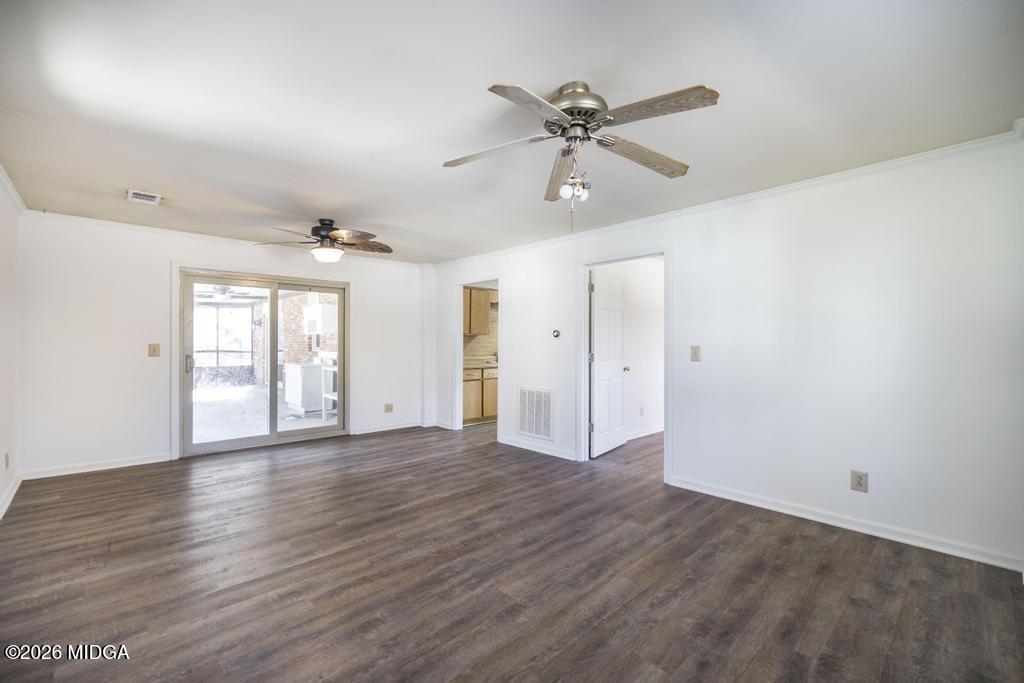 5624 Rogers Road Lizella, GA 31052 - Photo 26 of 39 a view of an empty room with window and wooden floor