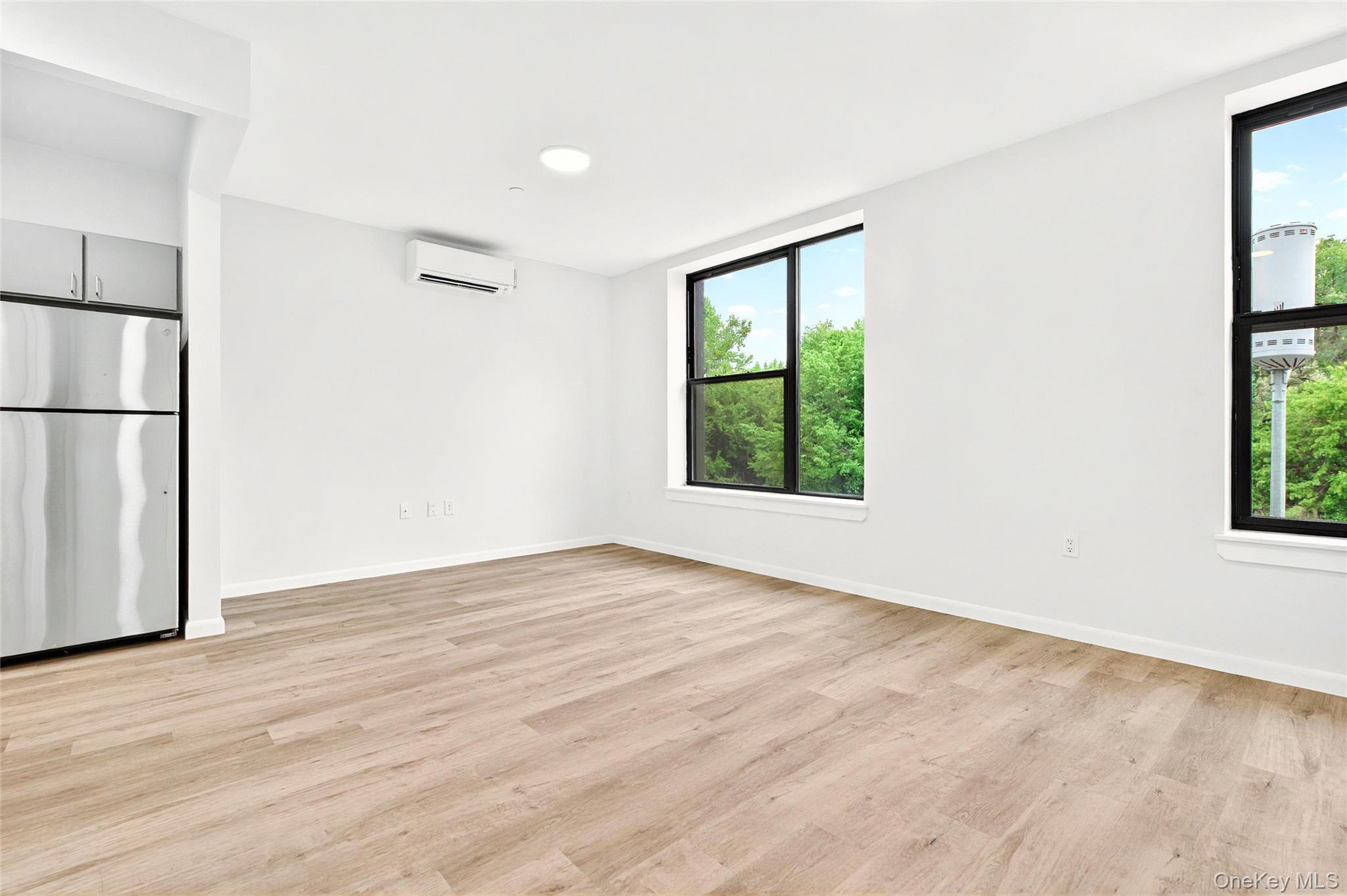 355 Bronx River Avenue, Unit 3B Bronx, NY 10473 - Photo 6 of 24 an empty room with wooden floor closet and windows