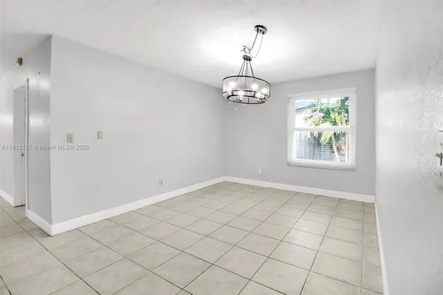 a view of a kitchen with a sink and chandelier