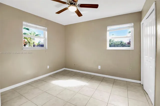 an empty room with windows and closet