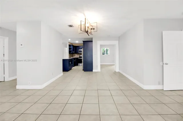 a view of a kitchen with a sink and a refrigerator