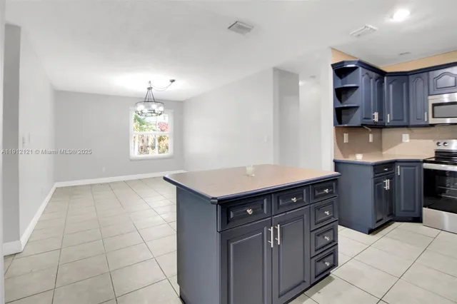 a kitchen with stainless steel appliances a refrigerator sink and cabinets