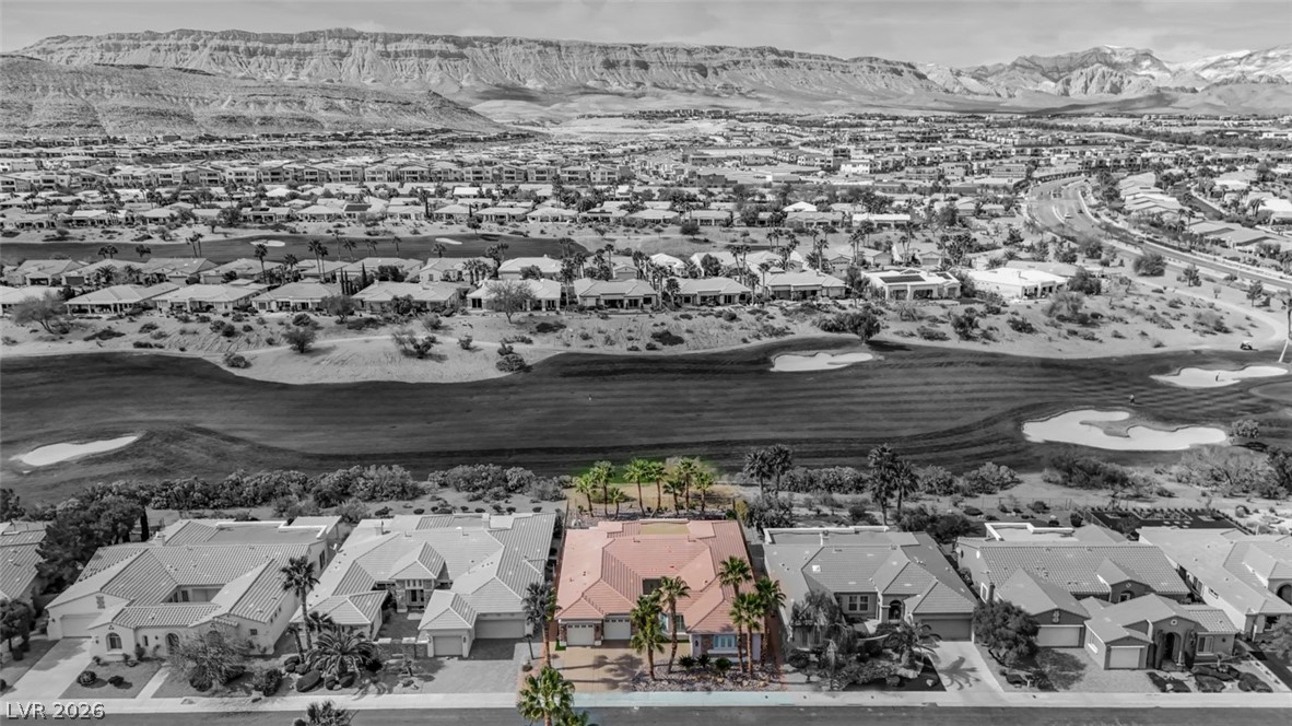 5015 Rivedro Street Las Vegas, NV 89135 - Photo 70 of 91 Panoramic golf course frontage and distant mountain views define this captivating aerial perspective.