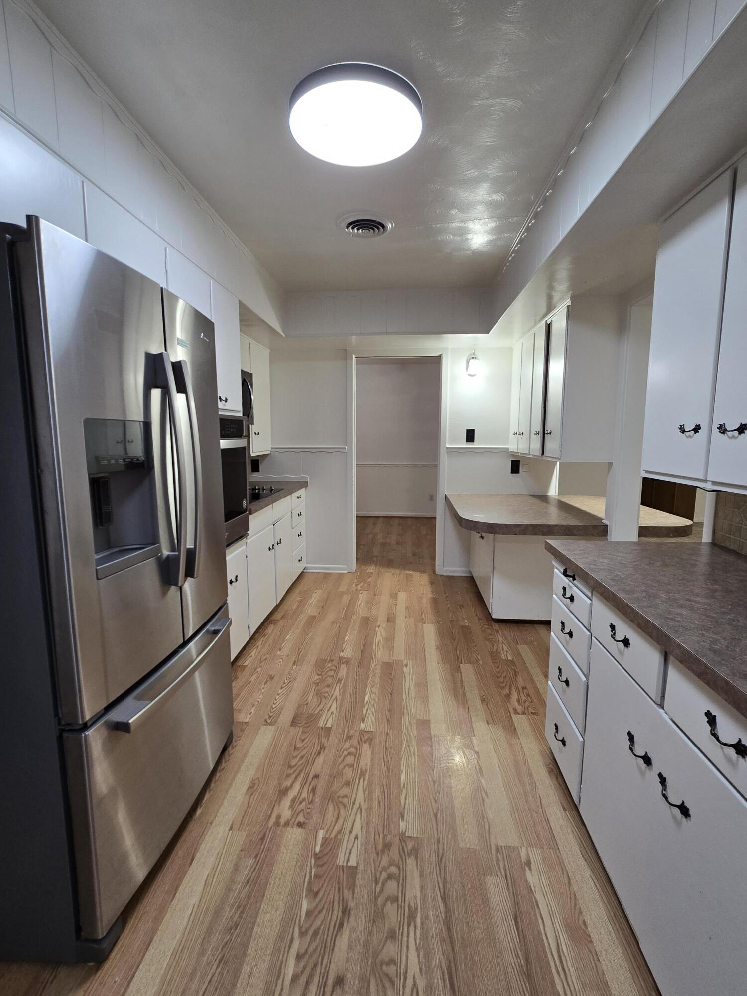 2229 South 6th Street Lamesa, TX 79331 - Photo 5 of 27 a kitchen with stainless steel appliances a refrigerator sink and microwave