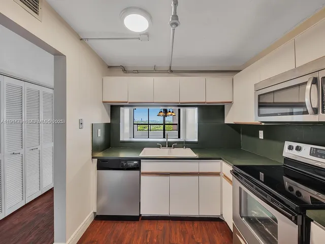 a kitchen that has a sink and a stove in it