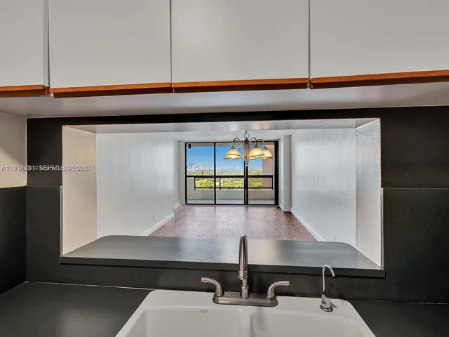 a room with table chair and window