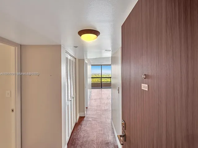 a view of a hallway with wooden shelves