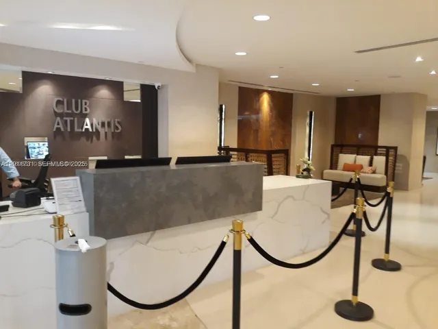 a living room with furniture and a projector screen