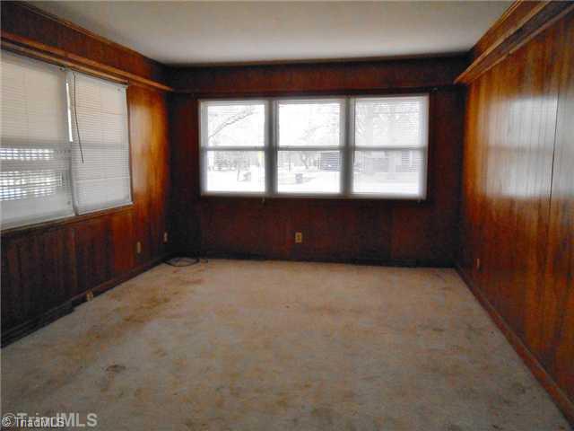 700 Sellars Mill Road Burlington, NC 27217 - Photo 3 of 7 Den/Family/Great Room. wood paneling, carpet with vinyl floored entry, & built in book shelves