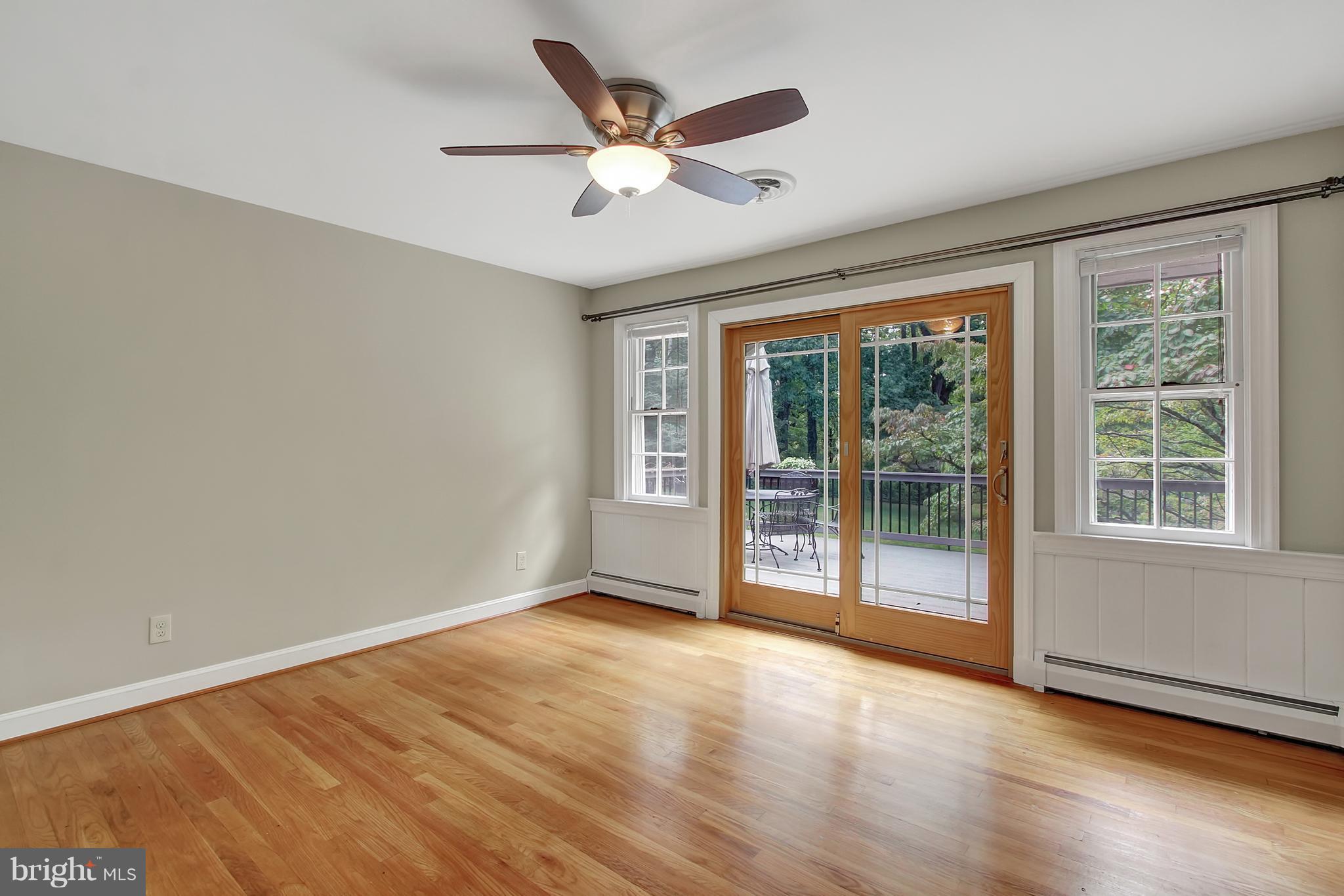 13617 Bardon Road Phoenix, MD 21131 - Photo 8 of 28 an empty room with wooden floor and ceiling fan