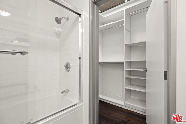 a living room with lots of furniture and kitchen view