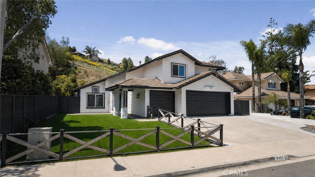16955 Lake Knoll Parkway Riverside, CA 92503 - Photo 2 of 42 a view of a white house with a yard and plants